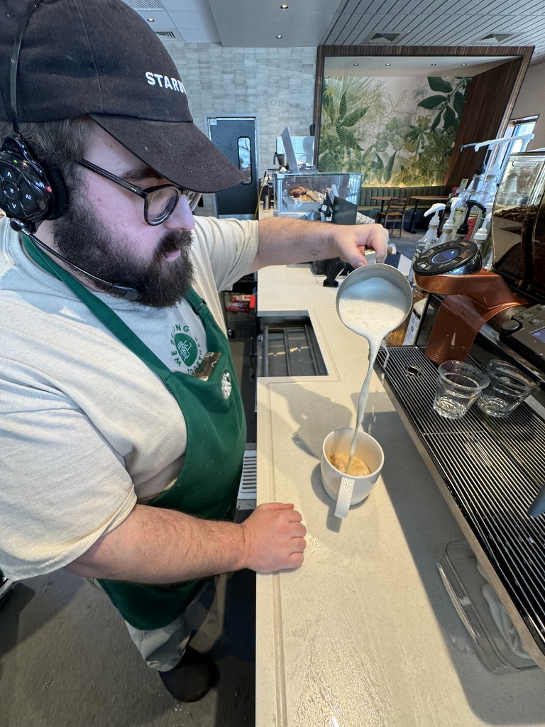 Kurt pouring milk into a drink